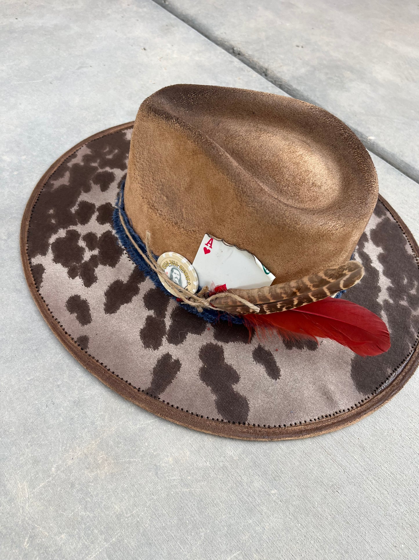 Tan cowhide burned fabric lined felt wide brim rancher hat
