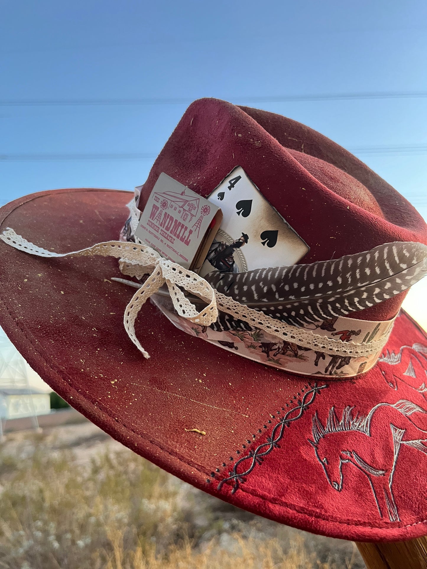 Distressed maroon burgandy horses burned accessorized suede wide brim rancher hat