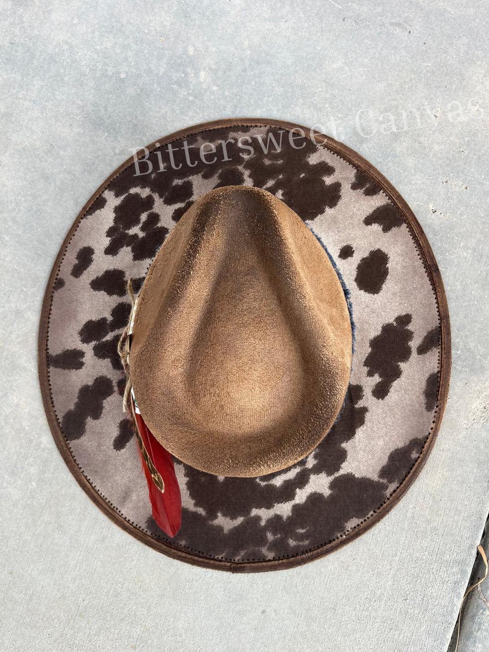 Tan cowhide burned fabric lined felt wide brim rancher hat
