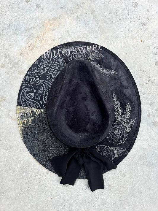 Black fabric lined floral accessorized burned suede wide brim rancher hat
