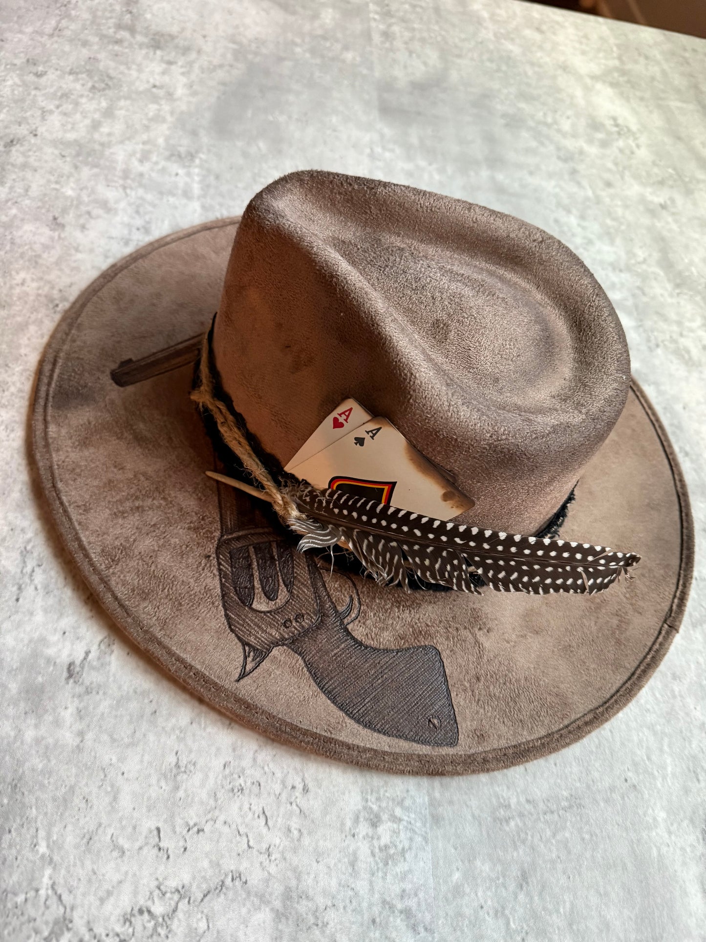 Brown revolver pistols burned wide brim rancher hat